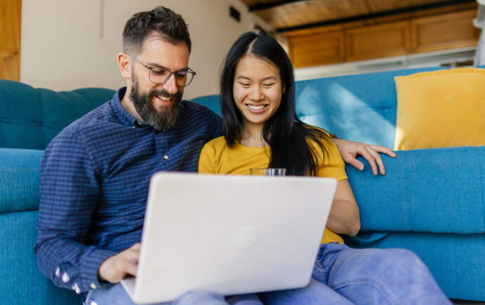 Young couple looking at finances on laptop