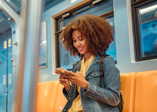 woman with smart phone on train